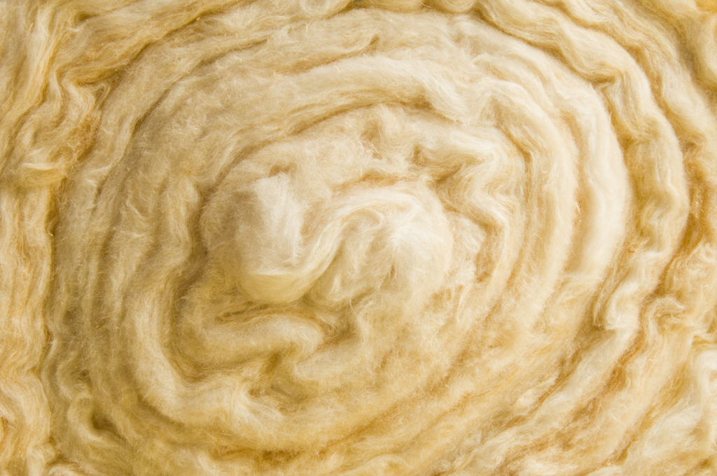 Close up of a roll of glass wool loft insulation.