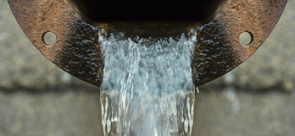 Close up image of a rusting water pipe