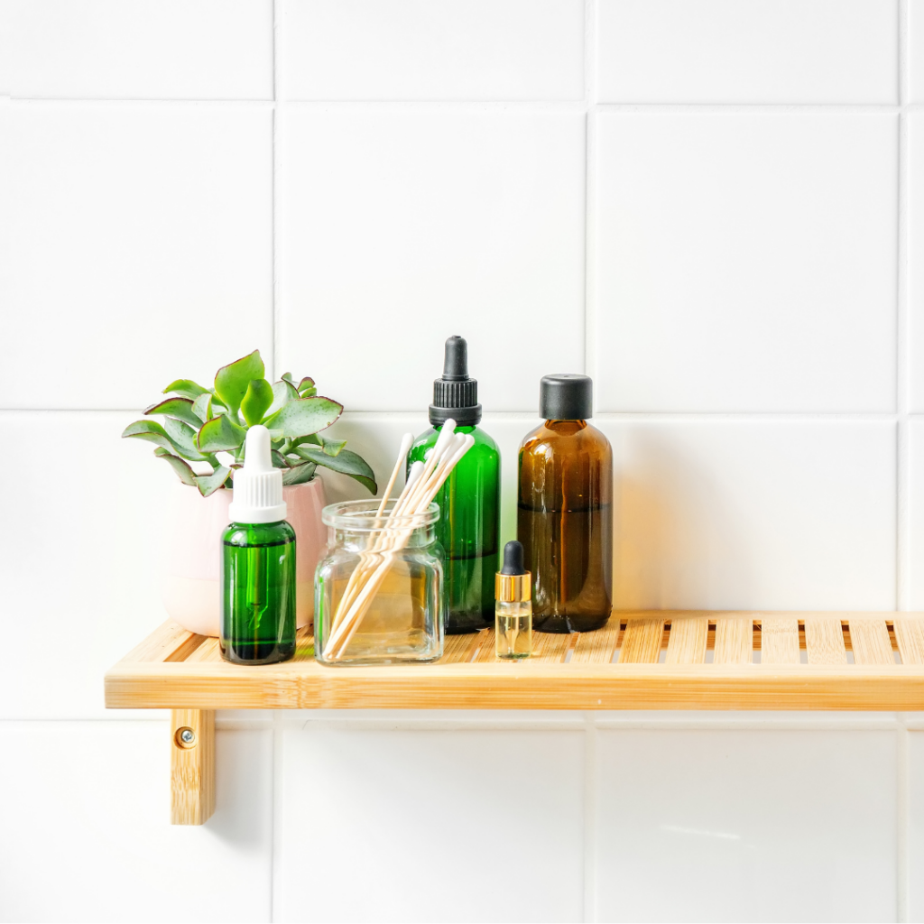 An image showing a wall mounted shelf in a bathroom with toiletries on it.