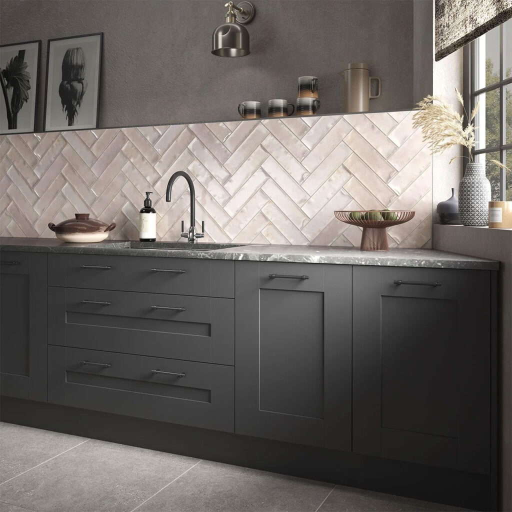 White herringbone styled tiles above a dark kitchen worktop